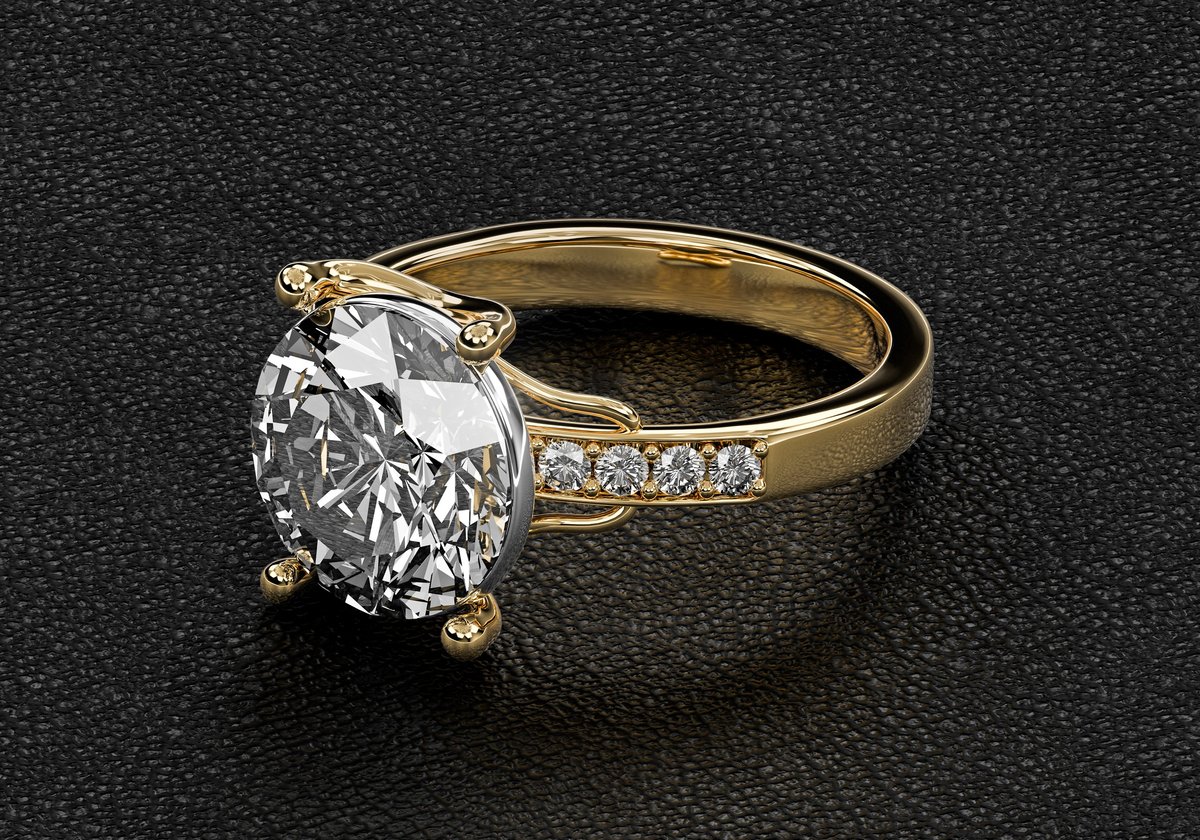 Gold and diamond ring on black leather